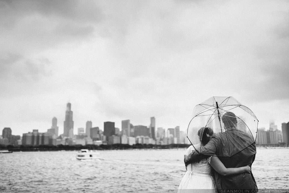 photo 030-bride-groom-chicago-skyline-lake-michigan-overcast-outdoors-umbrella-raining-black-white_zps65d92329.jpg